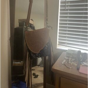 Myra cross body cow hide and leather with tassels. Also has concealed carry